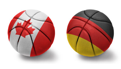 basketball balls with the national flags of germany and canada on the white background.