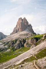 Landscapes of epic mountains during the sunset surrounded by clouds, with warm and cold lights. huge cliffs and epic views from the wild nature. 