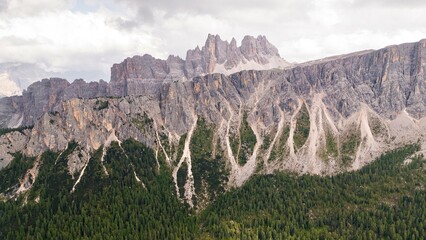 
Landscapes of epic mountains during the sunset surrounded by clouds, with warm and cold lights. huge cliffs and epic views from the wild nature. 