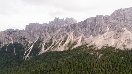 Fototapeta premium Landscapes of epic mountains during the sunset surrounded by clouds, with warm and cold lights. huge cliffs and epic views from the wild nature. 