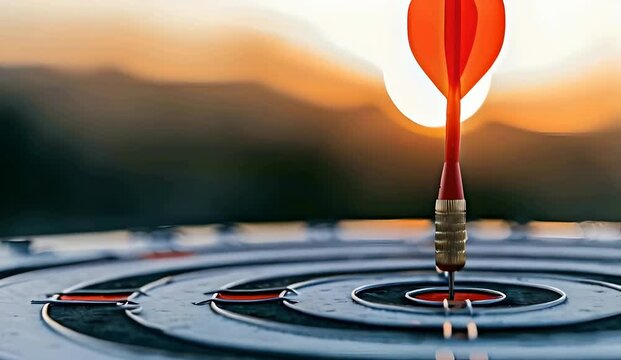 Red arrow hitting the center of a white dartboard with a sunset in the background, symbolizing success and achieving business goals, goal setting