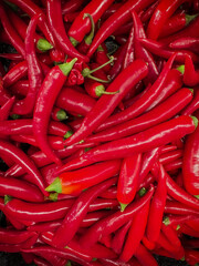 Red hot chilli peppers pattern texture background. Close up. Landscape. A backdrop of Red hot chilli peppers. Vegetable market. Group of Red hot chilli peppers