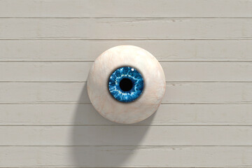 Blue eye staring from white wooden wall background