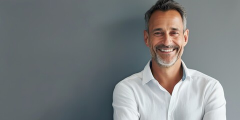 Fototapeta premium Smiling mature man's portrait, white background. Confident and happy senior businessman.