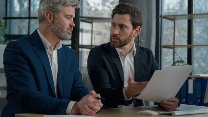 Caucasian men businessmen discussing agreement business documents in office dissatisfied leader employer disappointed with failed contract problem deal colleagues partners upset bad news tax penalty