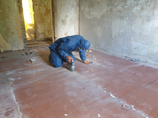 man in protective clothing, family doing renovation, people in masks, protection of upper respiratory tract from dust, dust from renovation, blue suit, glasses for eye protection, cutting floor, room 