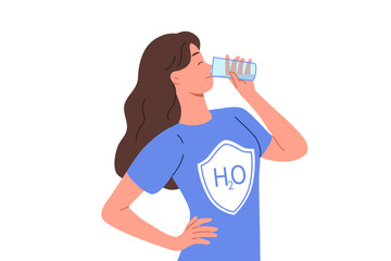 Woman drinks water from glass, dressed in t-shirt with h2o logo, uses aqua therapy to cleanse of toxins. Girl enjoys taste of purified mineral water obtained in environmentally friendly place