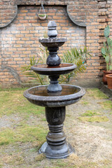Elegant Three-Tiered Marble Fountain in Garden