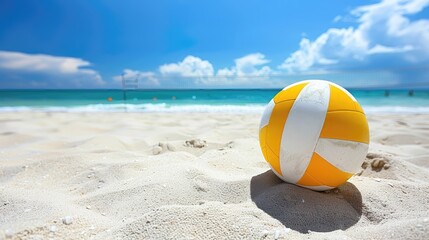 Obraz premium A yellow and white beach ball is sitting on the sand