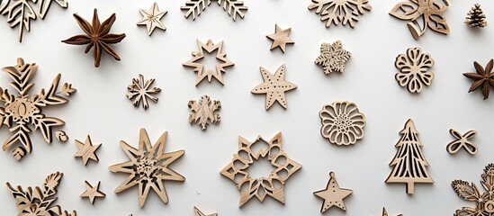 A top down view of wooden Christmas decorations against a white background with room for additional content in the image