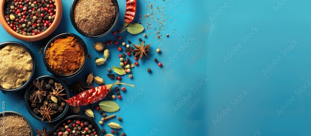 Poster spices arranged on a blue backdrop with copy space image