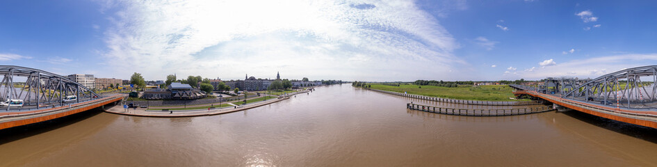 Fototapeta premium 360 Degrees panorama of steel draw bridge for train and traffic over the river IJssel with the Dutch Hanseatic city seen from above