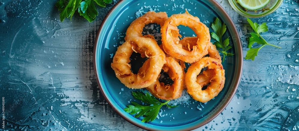 Poster copy space image of a plate with mediterranean style calamari rings battered squid fried briefly on 