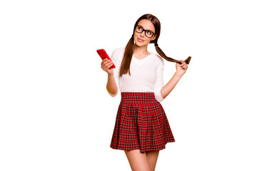 Portrait of nice-looking attractive lovely fascinating cheerful coquettish flirty girl wearing eyeglasses eyewear holding in hand blog post smm isolated on bright vivid shine yellow background