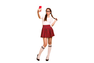 Full length body size view portrait of nice attractive lovely funky cheerful girl wearing uniform holding in hands cell making taking selfie plump lips isolated on bright vivid shine yellow background