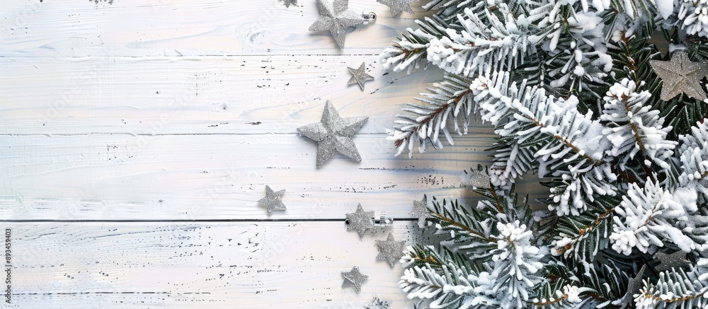 Poster snow covered christmas tree with silver stars on a white wooden backdrop forming a winter frame with