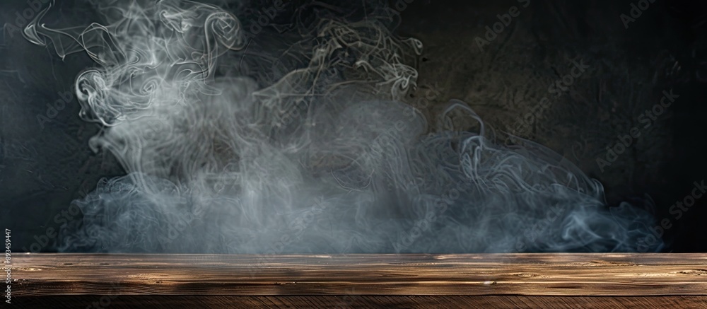 Poster A dark background showcases an empty wooden table with smoke rising providing a copy space image for product display