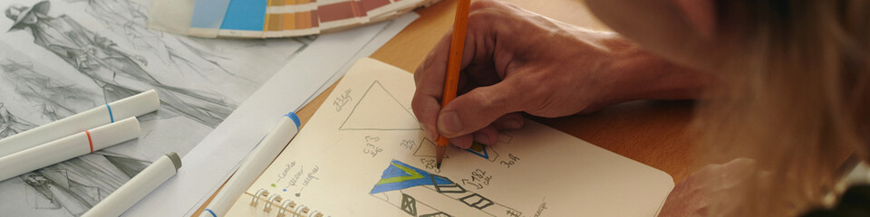 Header with fashion designer drawing in sketchbook