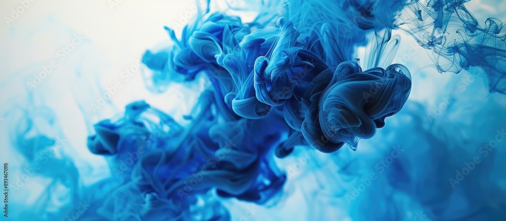 Poster Blue and black ink swirling in water, creating a colored abstract smoke explosion effect. Perfect for an abstract background with copy space image.