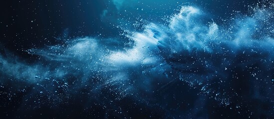 Obraz premium Freeze action of blue powder bursting on a dark background, forming an abstract white dust cloud explosion; ideal as a screensaver or wallpaper depicting creation of planets with copy space image.