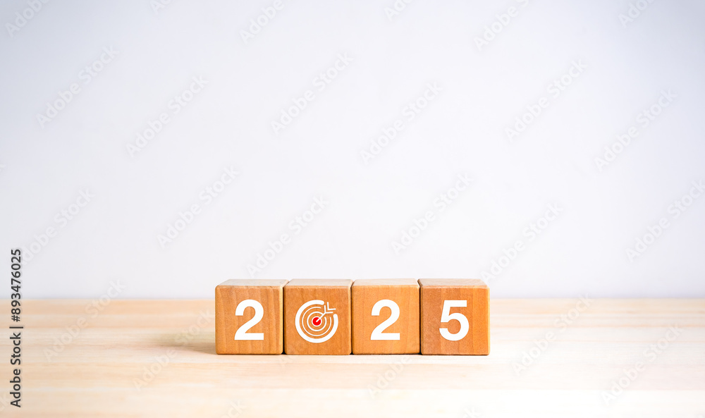 Wall mural 2025 Happy new year, simple horizontal banner. Numbers and target dart icon on wooden cube blocks isolated on wood table, white background with copy space. 2025 Business goal plan, eco style concept.