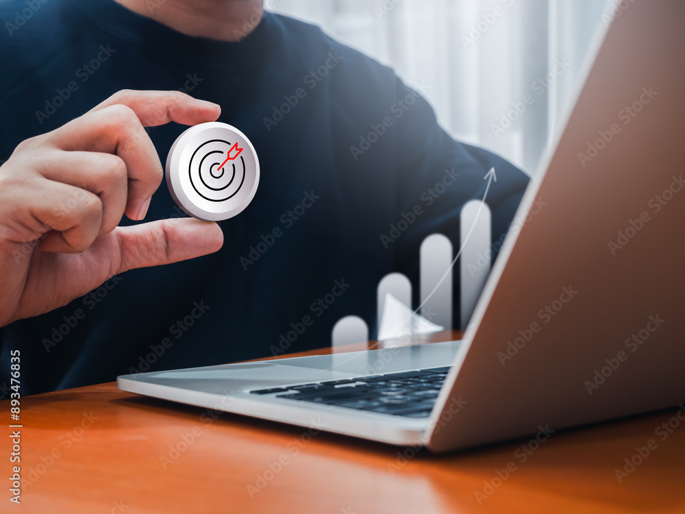 Poster 3d target icon badge holding by businessman while working with laptop computer with digital growth g