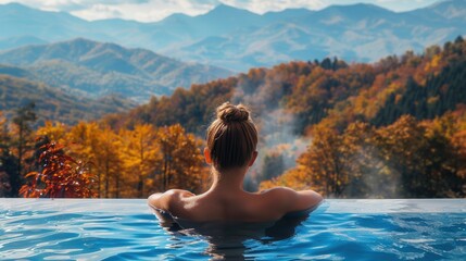 Back view of a female in spa pool with beautiful scenic view in Autumn