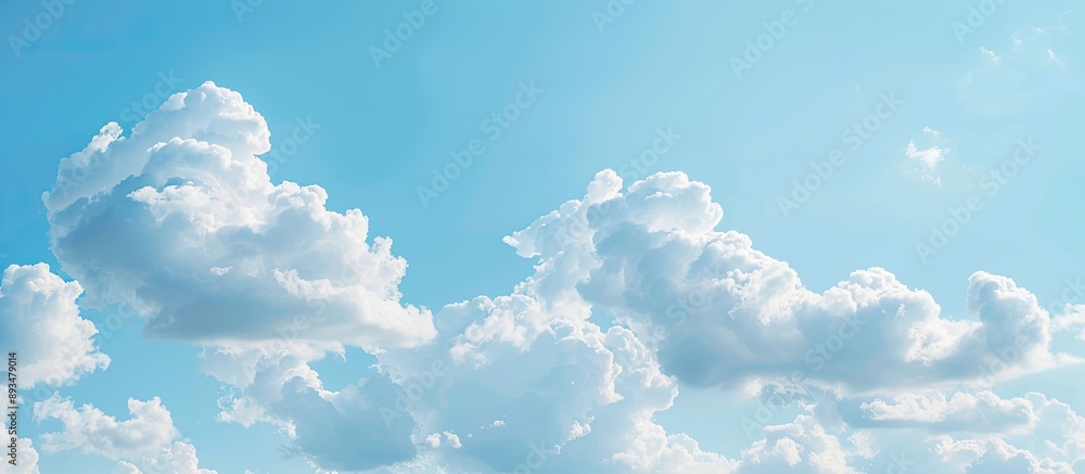 Poster background of a clear blue sky with fluffy white clouds perfect for copy space image