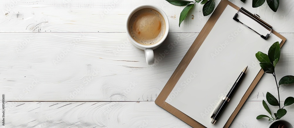 Poster Creative coffee themed desk setup with a clipboard pen and mug on a white background for a flat lay top view image with copy space