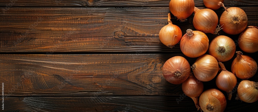 Poster Black wooden table background displaying onions with copy space image