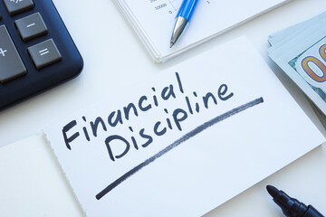 Open notepad with inscription financial discipline and money.
