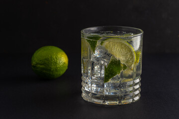 Lime slice with a sparkling water in a glass. Summer drink concept.