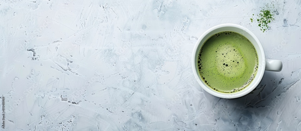 Aufkleber Bird s eye view of a cup filled with matcha green tea on a blank white surface with space for text or other elements creating a copy space image