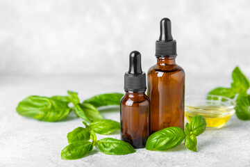 Basil essential oil on a textured wooden background. Basil essential oil and fresh leaves. Aromatherapy. Aroma oil. Medical herbs. Alternative medicine. Place for text. Copy space.