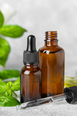 Basil essential oil on a textured wooden background. Basil essential oil and fresh leaves. Aromatherapy. Aroma oil. Medical herbs. Alternative medicine. Place for text. Copy space.