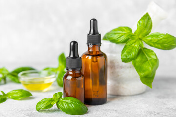 Basil essential oil on a textured wooden background. Basil essential oil and fresh leaves. Aromatherapy. Aroma oil. Medical herbs. Alternative medicine. Place for text. Copy space.