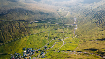 Funningur village, Faroe Islands. Sunny day in summer. Amazing nature in Faroe Islands. Eysturoy Island. Gonguturur or Hvithamar Trailhead. Faroese fjord and summits