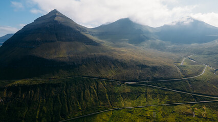 Funningur village, Faroe Islands. Sunny day in summer. Amazing nature in Faroe Islands. Eysturoy Island. Gonguturur or Hvithamar Trailhead. Faroese fjord and summits