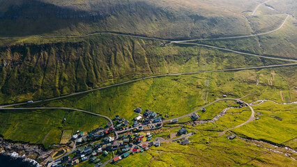 Funningur village, Faroe Islands. Sunny day in summer. Amazing nature in Faroe Islands. Eysturoy Island. Gonguturur or Hvithamar Trailhead. Faroese fjord and summits