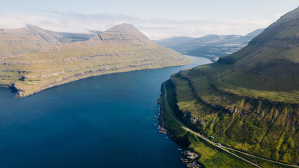 Funningur village, Faroe Islands. Sunny day in summer. Amazing nature in Faroe Islands. Eysturoy Island. Gonguturur or Hvithamar Trailhead. Faroese fjord and summits