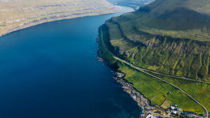 Funningur village, Faroe Islands. Sunny day in summer. Amazing nature in Faroe Islands. Eysturoy Island. Gonguturur or Hvithamar Trailhead. Faroese fjord and summits