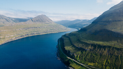 Funningur village, Faroe Islands. Sunny day in summer. Amazing nature in Faroe Islands. Eysturoy Island. Gonguturur or Hvithamar Trailhead. Faroese fjord and summits