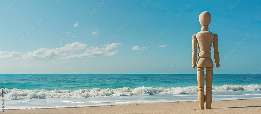 Aufkleber wooden mannequin on a sandy beach with ocean in background during summer perfect for copy space imag