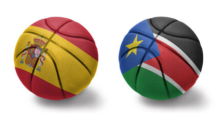 basketball balls with the national flags of spain and south sudan on the white background.