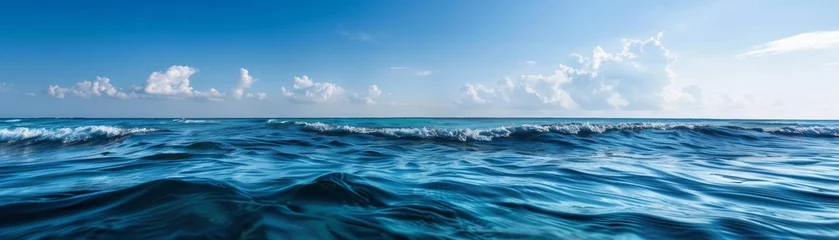 Store enrouleur Vagues de l'océan The ocean is calm and blue with no clouds in the sky  © Chayan