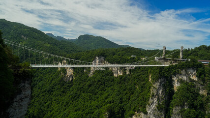 Glass bridge of Zhangjiajie China Tianzishan with blue sky, Zhangjiajie national forest park, China, concept of world heritage, avatar, heritage peak or cliff mountain, tourist attraction famous place