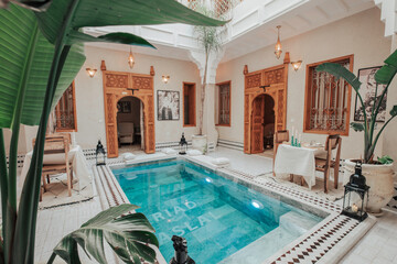 an amazing riad in marrakech its name Riad Aslal, and breakfast table with pool and on the pool...