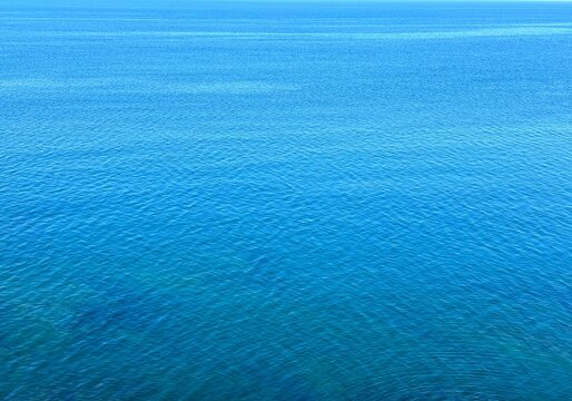 Blue calm ocean water background 