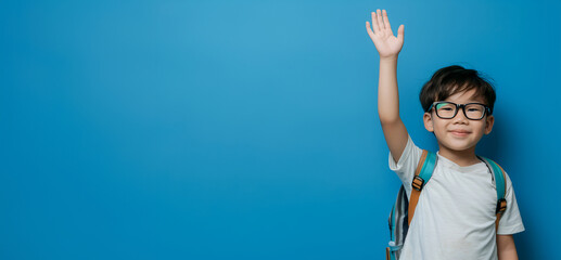 Young student raising hand with enthusiasm for learning