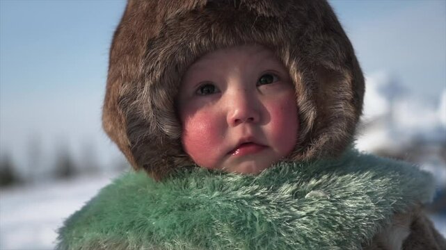 Portrait of a child from Yamal in clothes made of reindeer skins